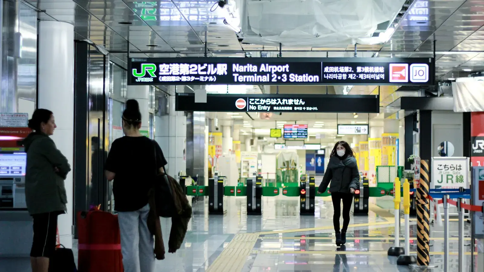 Travellers walking through an airport concourse