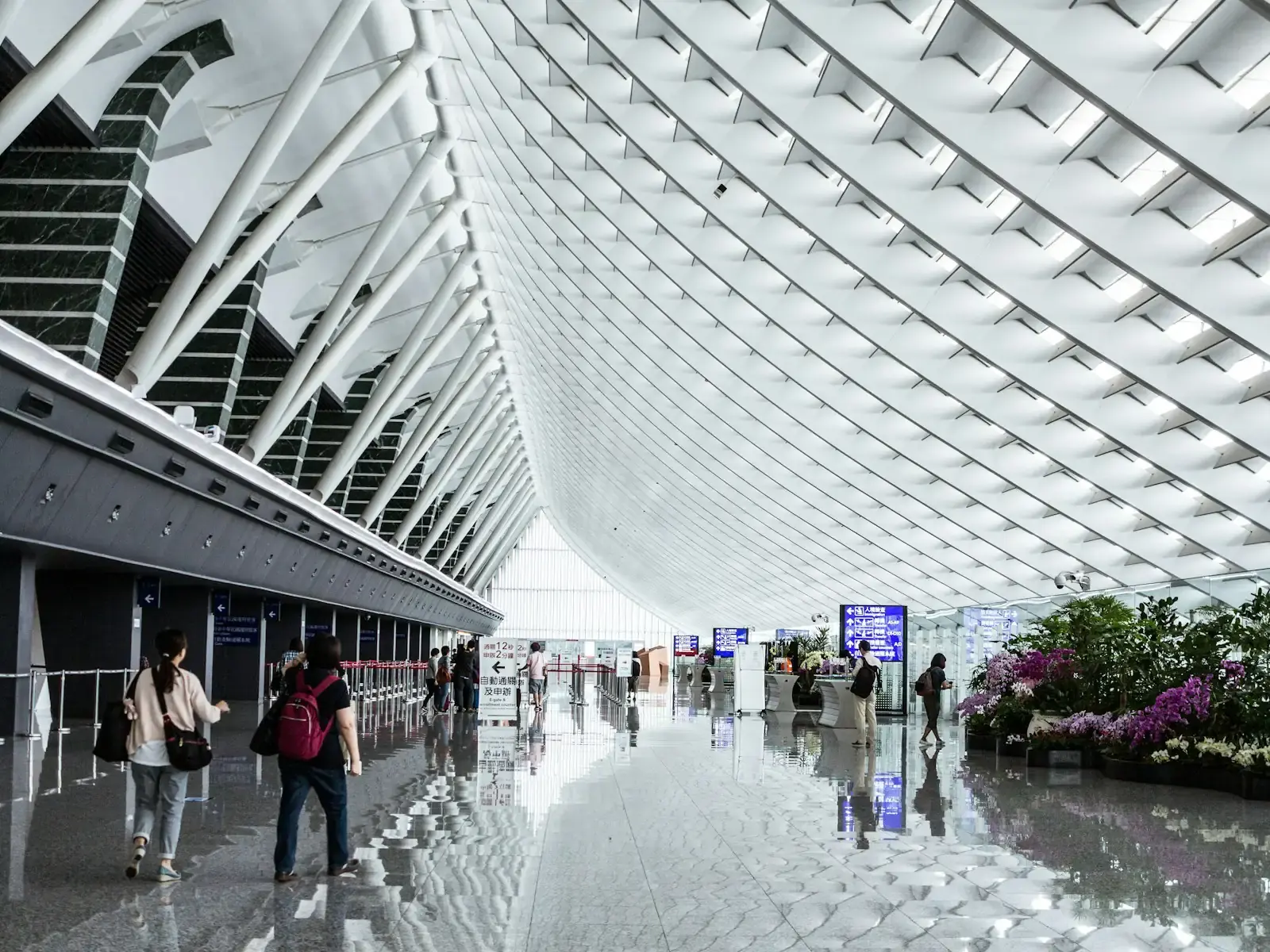 People walking through a bright airport departure hall
