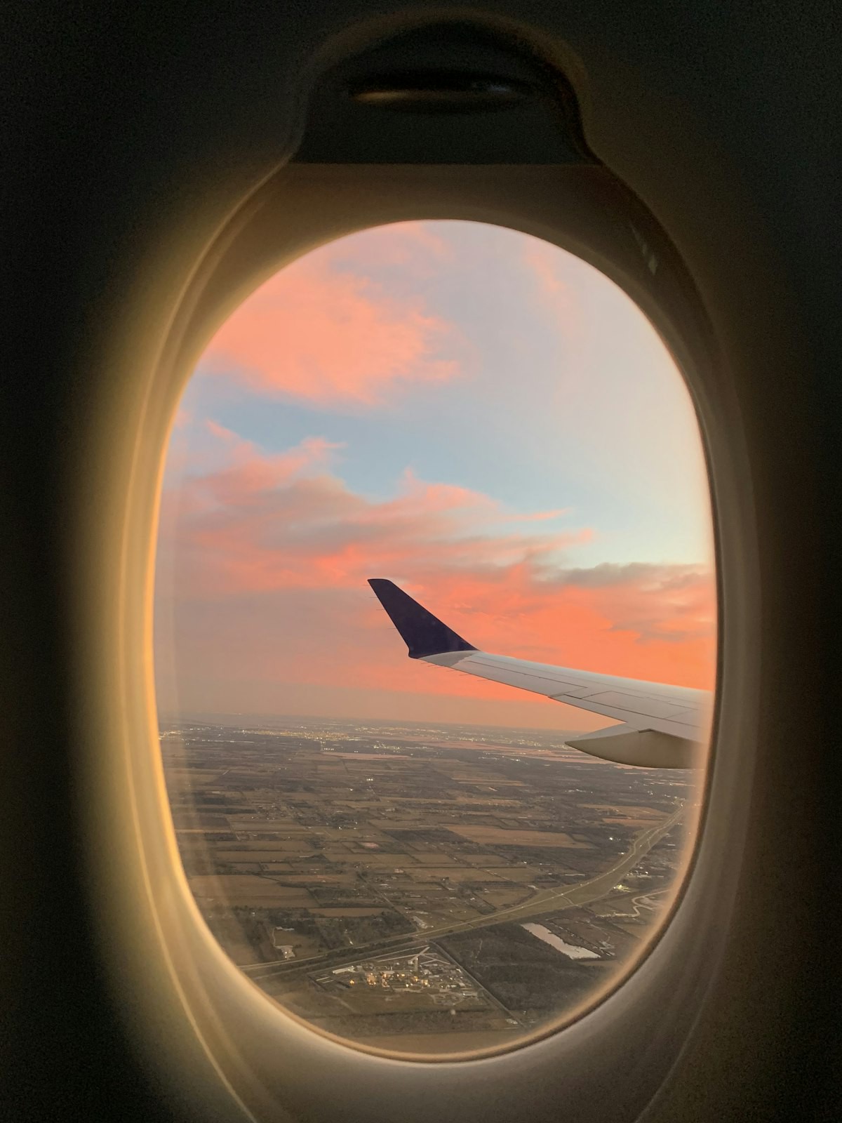 A sunset sky seen through an airplane window